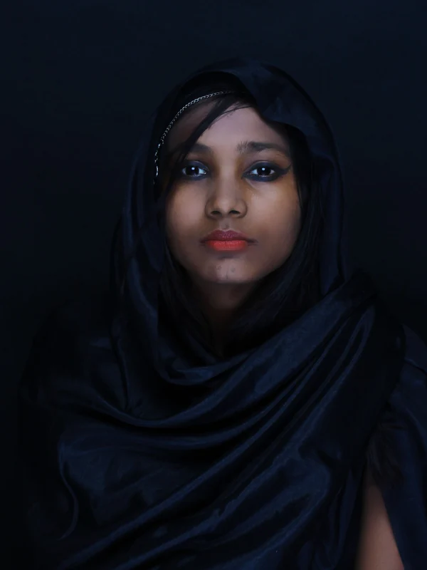 Illustrative: a black hijab worn close to the face, studio portrait. Licensed stock photograph, not our own product.