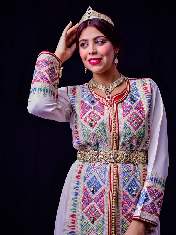 Illustrative: a kaftan with woven embroidery and a jewelled belt, styled for an occasion. Licensed stock photograph, not our own product.