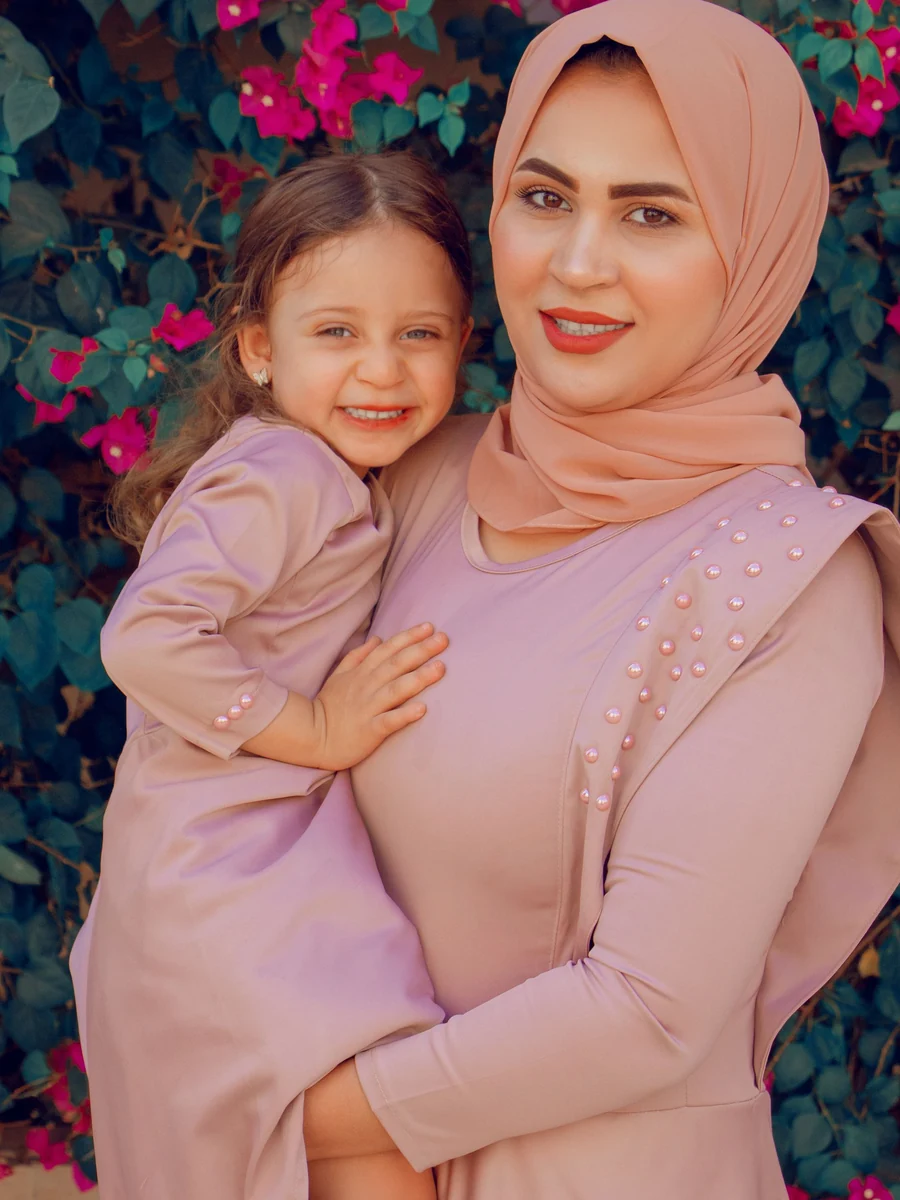 Illustrative: kids abaya wholesale — a mother and daughter in matching pink outfits. Licensed stock photograph, not our own product.