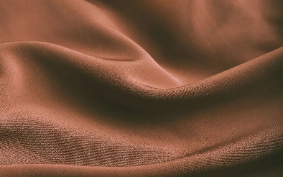 Close-up of Armani silk, a heavier satin-faced cloth used for occasion pieces.