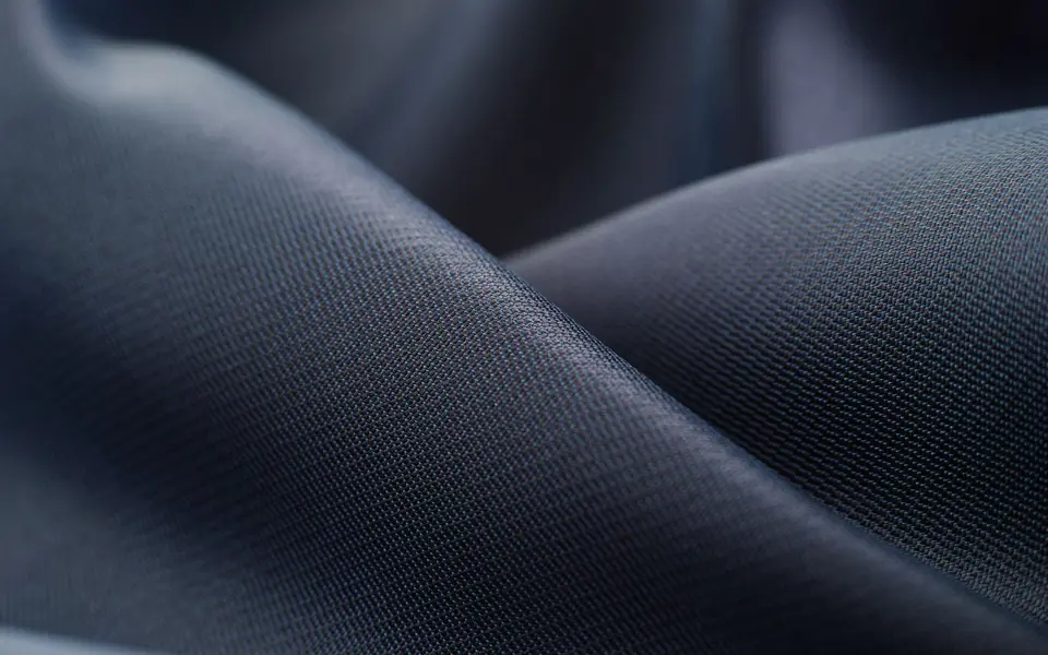 Close-up of grey-blue fabric with a visible grid weave
