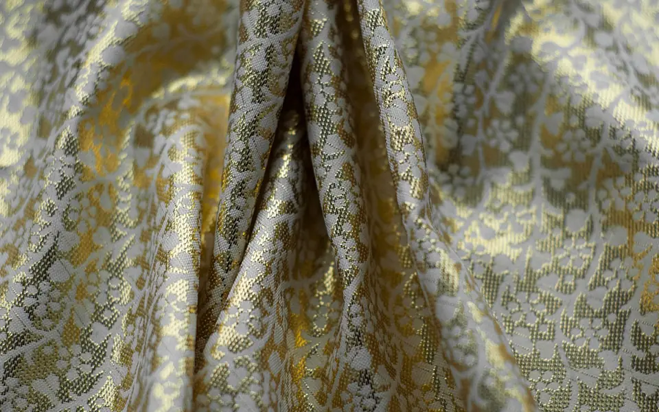 Close-up of brocade, woven with a raised pattern.