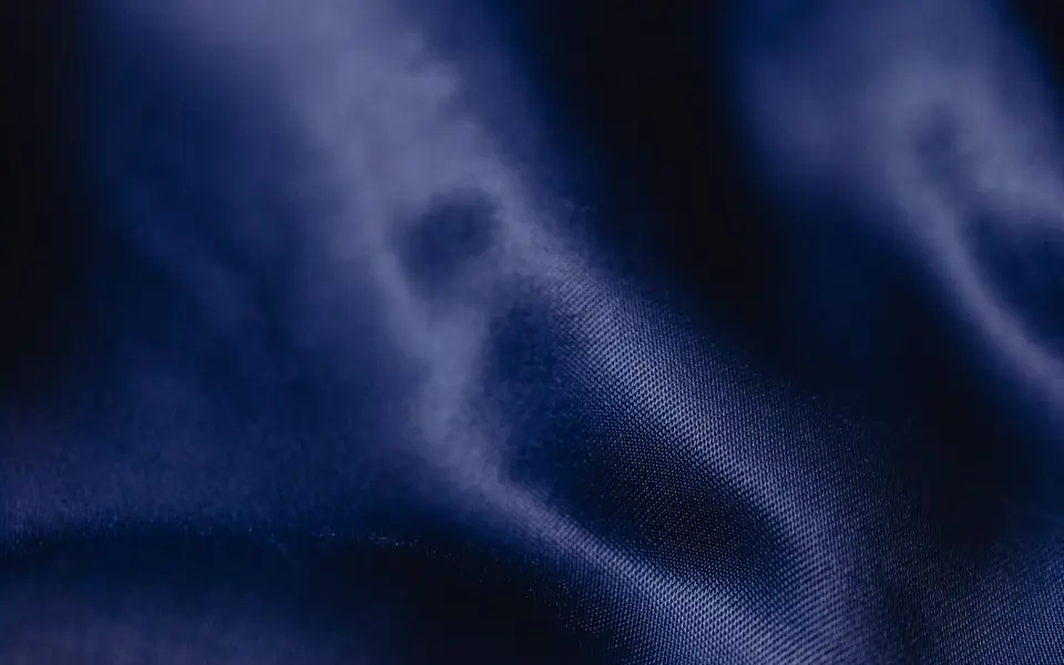 Close-up of blue satin with a visible weave under the sheen