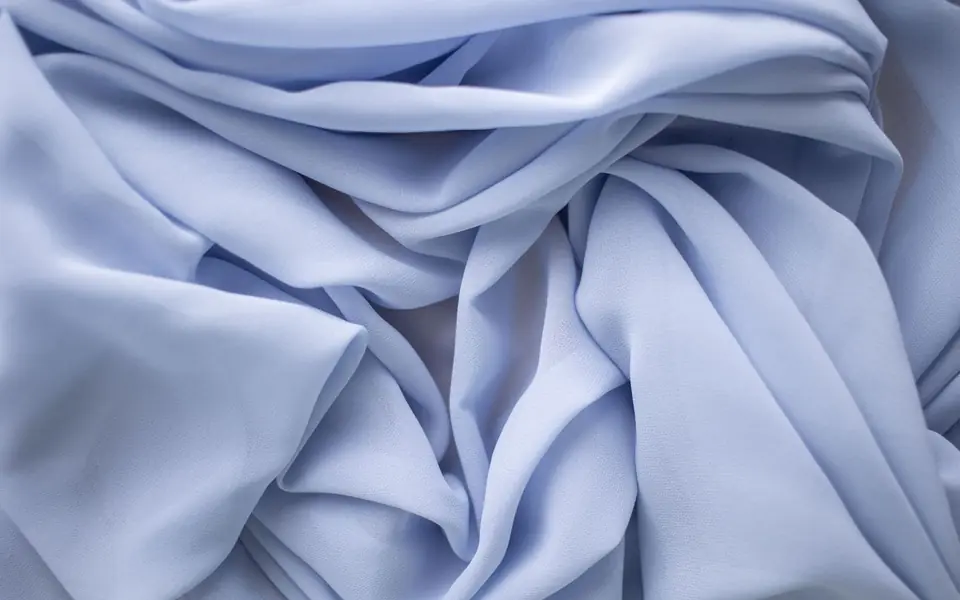 Close-up of pale blue sheer fabric with soft wrinkles