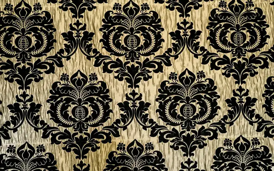 Close-up of a black damask pattern woven on a cream ground
