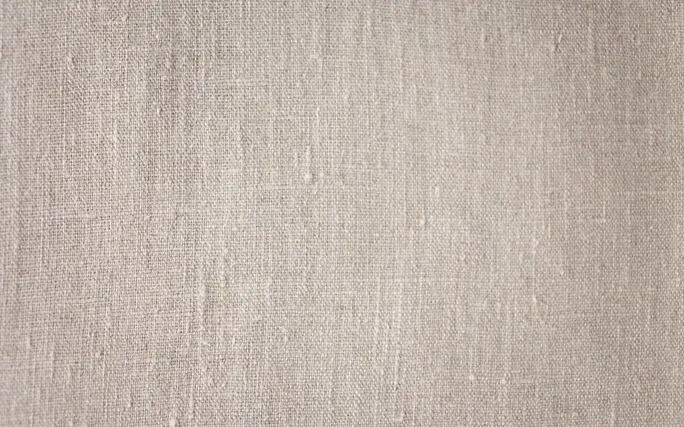 Close-up of linen showing its natural slub texture and open weave.