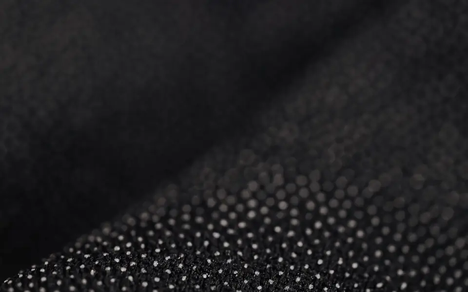 Close-up of black fabric with a fine dotted surface texture