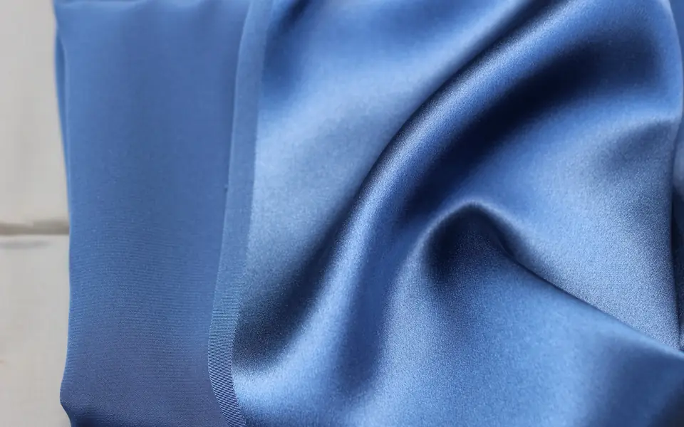 Blue 100% silk charmeuse, showing the glossy face and the matte back
