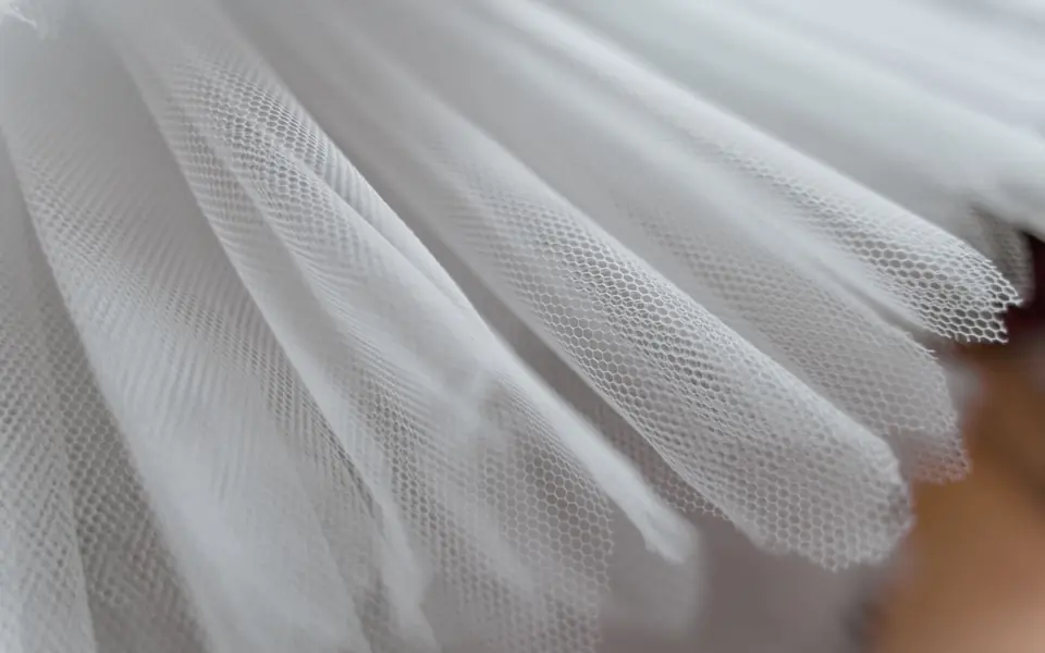 Close-up of white tulle showing the honeycomb mesh