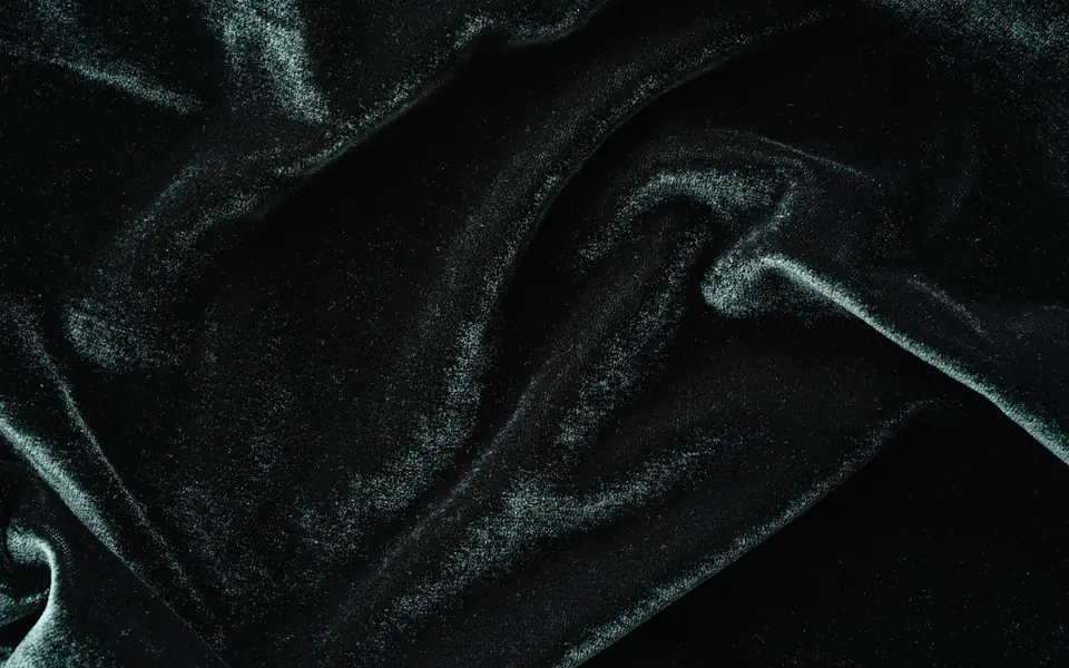 Close-up of dark teal velvet with visible pile and sheen
