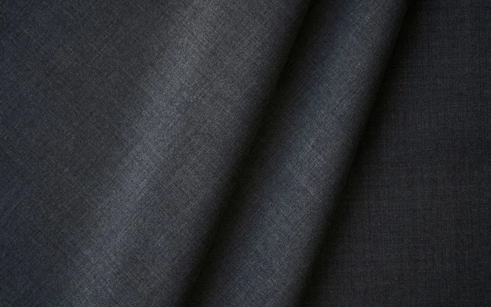Close-up of charcoal grey woven suiting fabric
