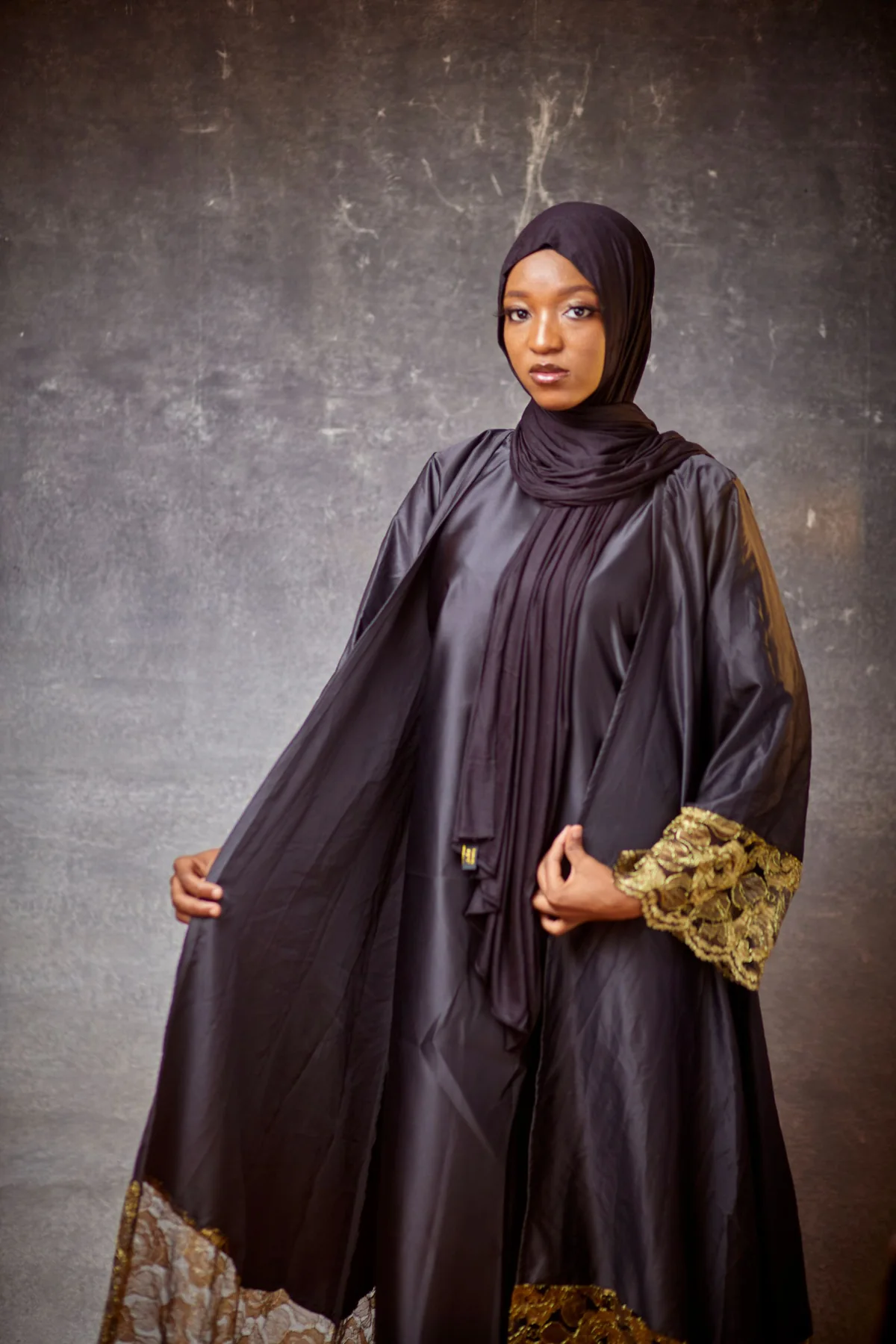 Illustrative: a detailed abaya photographed on a model. Licensed stock photograph, not our own product.