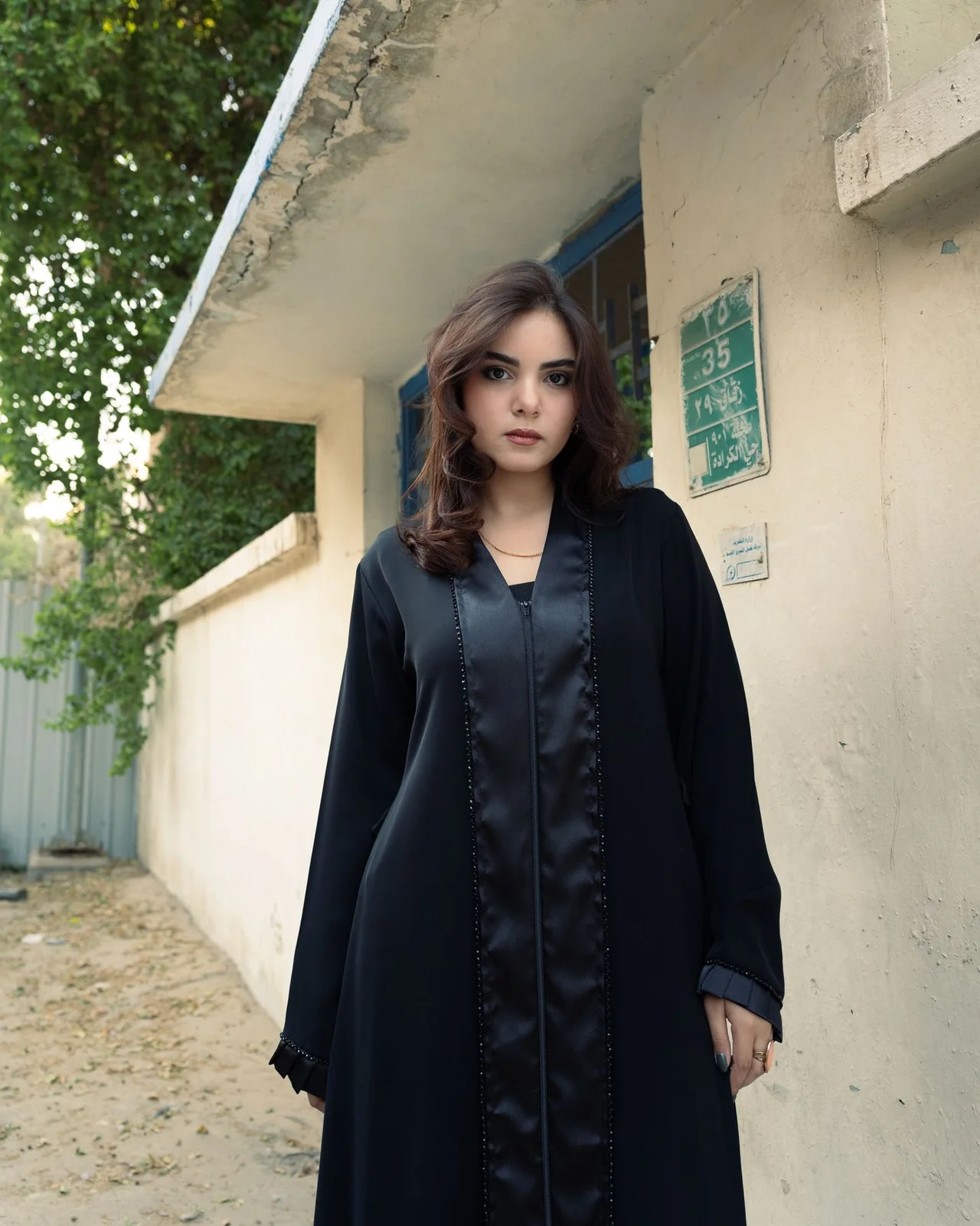 Illustrative: a classic black abaya with a satin front placket. Licensed stock photograph, not our own product.