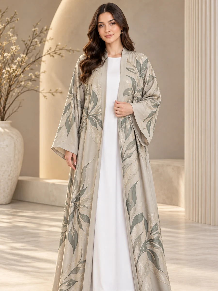 Wholesale kimono abaya: a sage open abaya with leaf embroidery and wide kimono sleeves over a white inner dress (illustrative image)