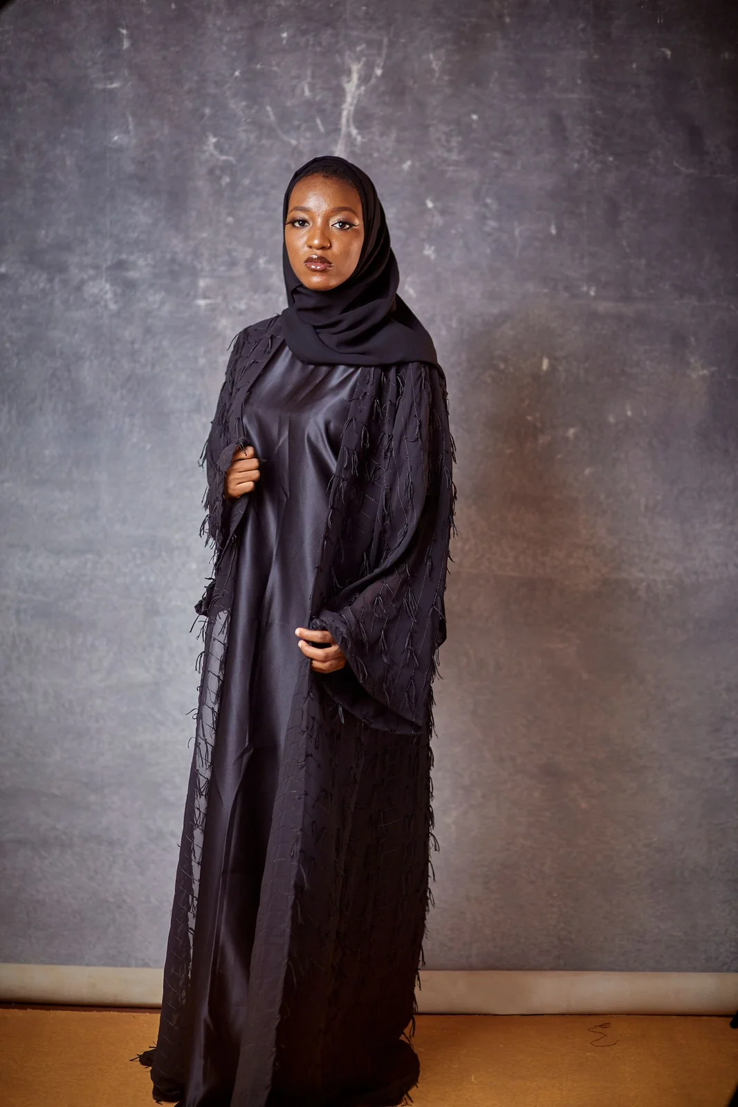 Illustrative: layered abaya styling. Licensed stock photograph, not our own product.