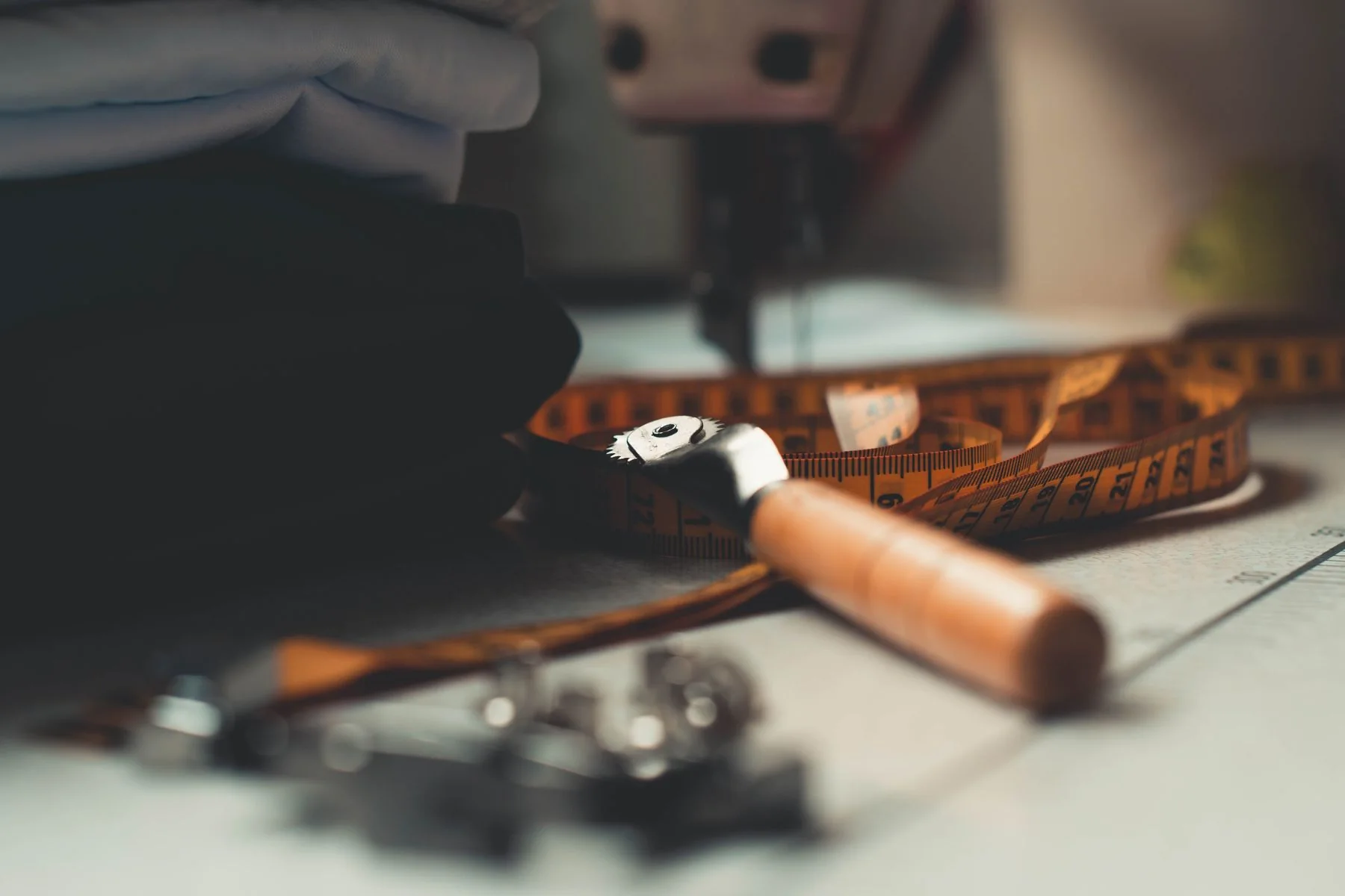 Illustrative: shears, chalk and measuring tools on a bench. Licensed stock photograph.